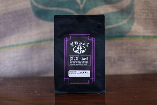 Cafe Kubal's Decaf Brazil Roast. Pictured in front of a burlap sack.
